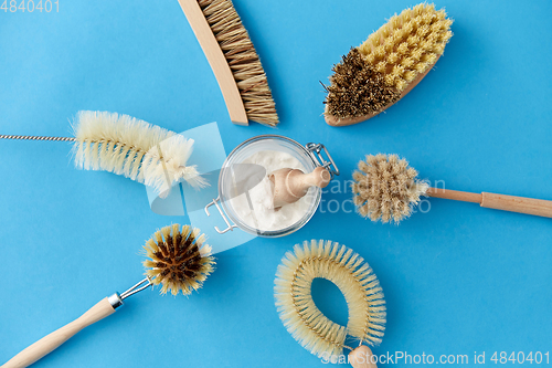 Image of cleaning brushes and soda powder with scoop in jar