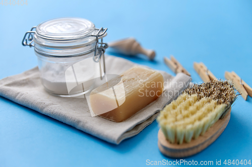 Image of brush, washing soda, soap, scoop and clothespins