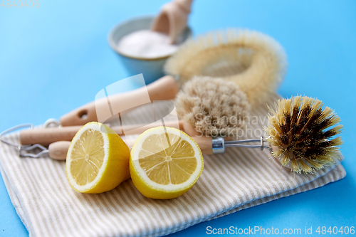 Image of cleaning brushes, lemon and washing soda on cloth