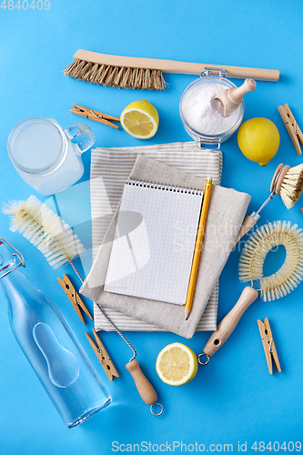 Image of notebook with pencil and natural cleaning supplies