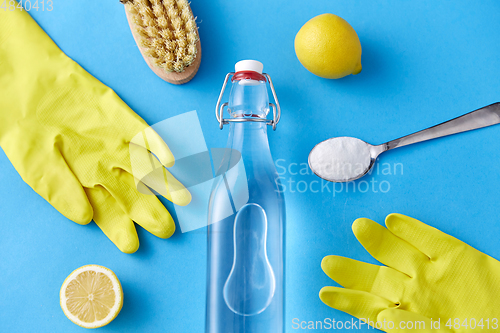 Image of vinegar, lemons, washing soda, gloves and brush