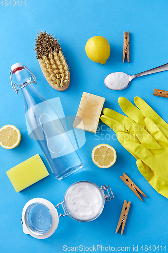 Image of vinegar, lemons, washing soda, gloves and brush