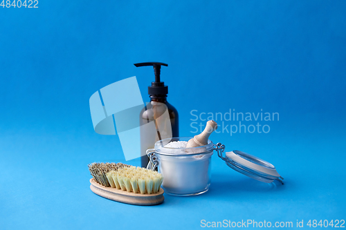 Image of cleaning brush, soda with scoop and liquid soap