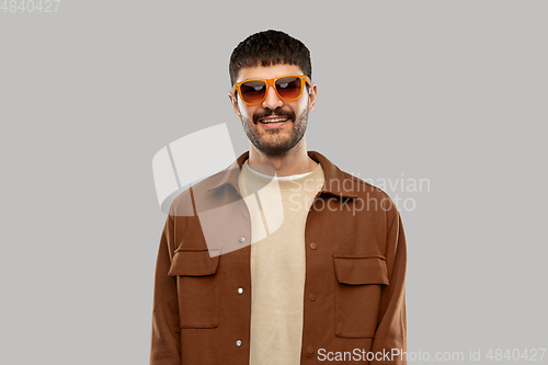 Image of smiling young man in sunglasses