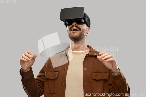 Image of happy smiling young man in vr glasses