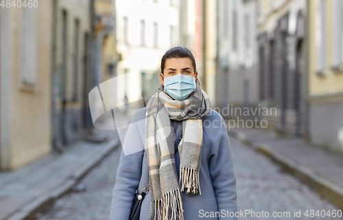 Image of young woman wearing protective medical mask