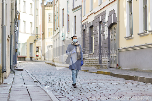 Image of young woman wearing protective medical mask