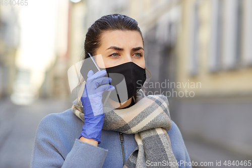 Image of woman in protective reusable mask calling on phone