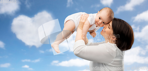 Image of happy middle-aged mother with baby over sky