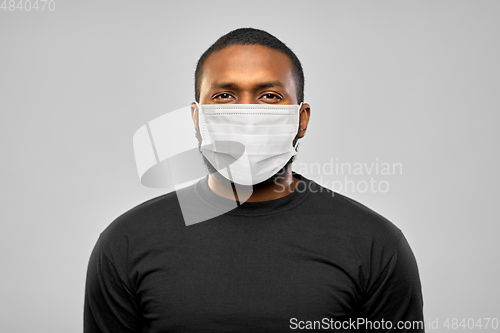 Image of african american man in protective medical mask