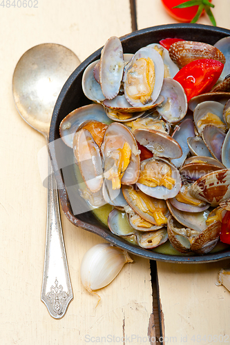 Image of fresh clams on an iron skillet