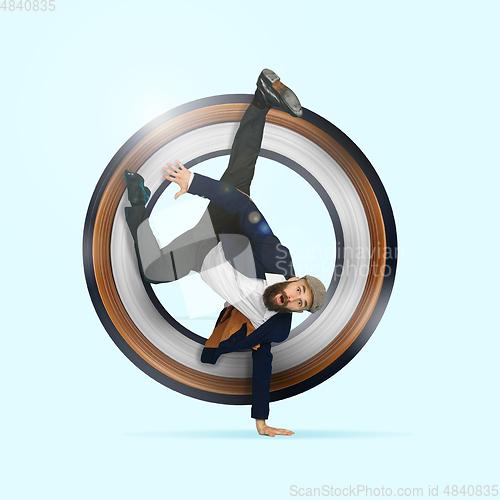 Image of Businessman having fun dancing break dance on blue background at work