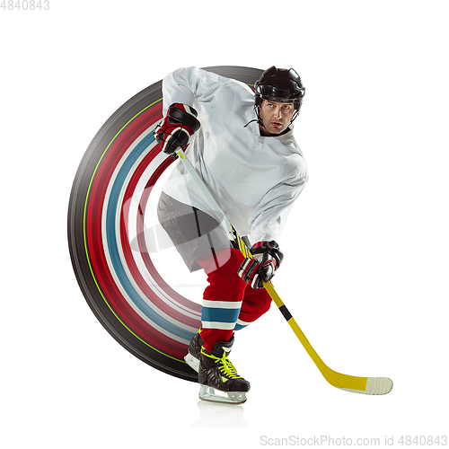 Image of Young male hockey player with the stick on ice court and white background