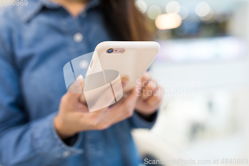 Image of Woman sending sms on mobile phone