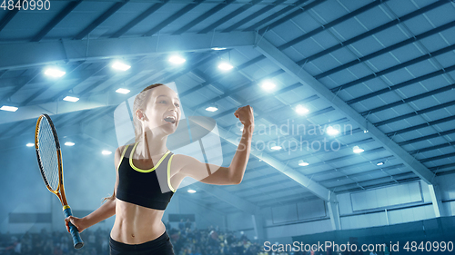 Image of Little caucasian girl playing tennis on sport court background