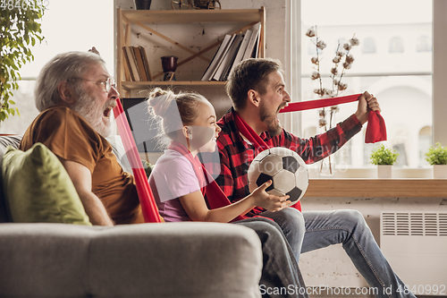 Image of Excited, happy big family team watch football, soccer match together on the couch at home