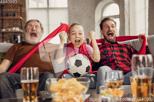 Image of Excited, happy big family team watch football, soccer match together on the couch at home