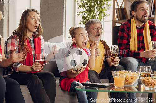 Image of Excited, happy big family team watch football, soccer match together on the couch at home