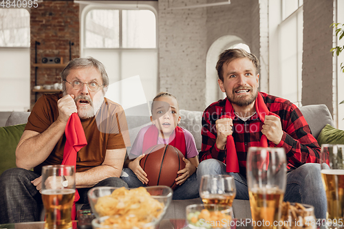 Image of Excited, happy big family team watch sport match together on the couch at home
