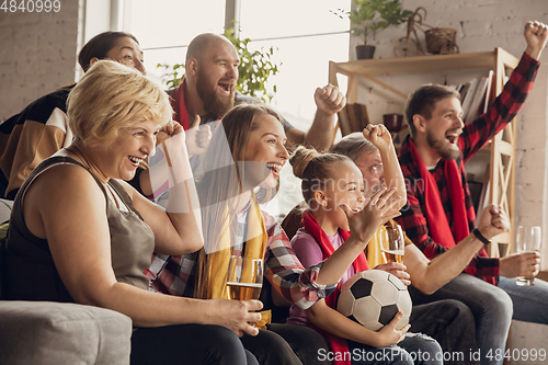 Image of Excited, happy big family team watch football, soccer match together on the couch at home