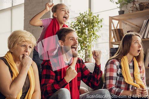 Image of Excited, happy big family team watch football, soccer match together on the couch at home