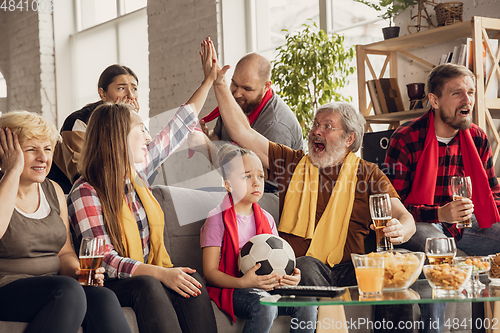 Image of Excited, happy big family team watch football, soccer match together on the couch at home