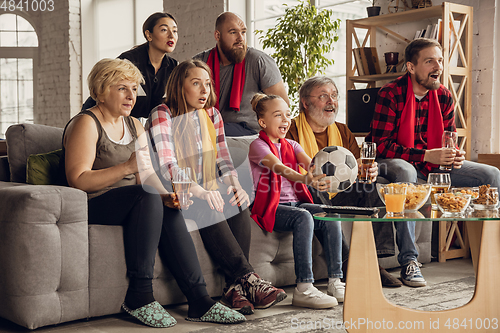 Image of Excited, happy big family team watch football, soccer match together on the couch at home