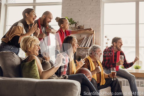 Image of Excited, happy big family team watch sport match together on the couch at home