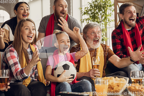 Image of Excited, happy big family team watch football, soccer match together on the couch at home