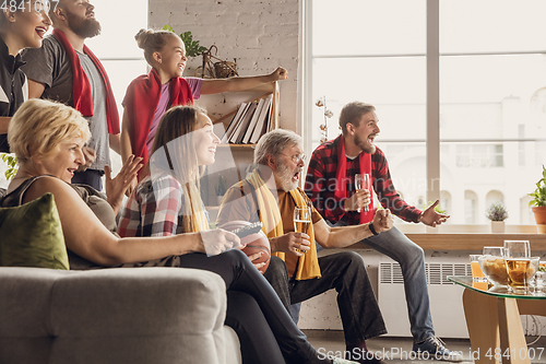 Image of Excited, happy big family team watch football, soccer match together on the couch at home