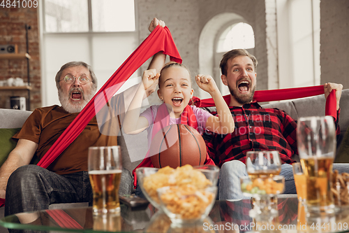 Image of Excited, happy big family team watch sport match together on the couch at home