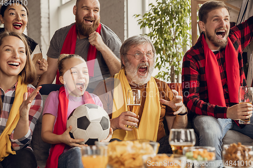 Image of Excited, happy big family team watch football, soccer match together on the couch at home