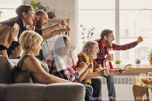 Image of Excited, happy big family team watch football, soccer match together on the couch at home