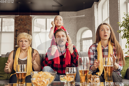 Image of Excited, happy big family team watch football, soccer match together on the couch at home