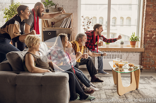 Image of Excited, happy big family team watch football, soccer match together on the couch at home