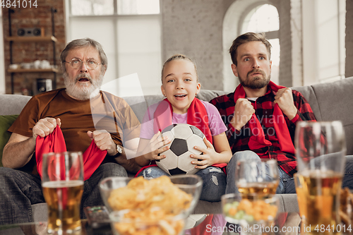 Image of Excited, happy big family team watch football, soccer match together on the couch at home