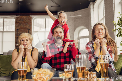 Image of Excited, happy big family team watch football, soccer match together on the couch at home
