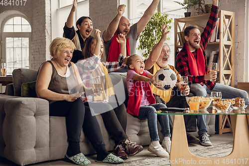 Image of Excited, happy big family team watch football, soccer match together on the couch at home