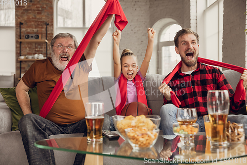 Image of Excited, happy big family team watch sport match together on the couch at home