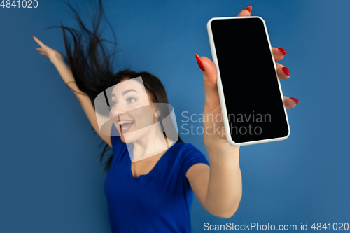 Image of Caucasian woman\'s portrait isolated on blue studio background