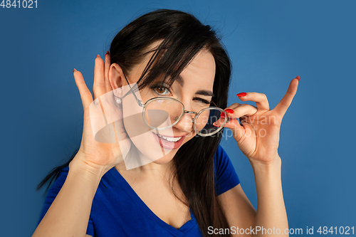 Image of Caucasian woman\'s portrait isolated on blue studio background