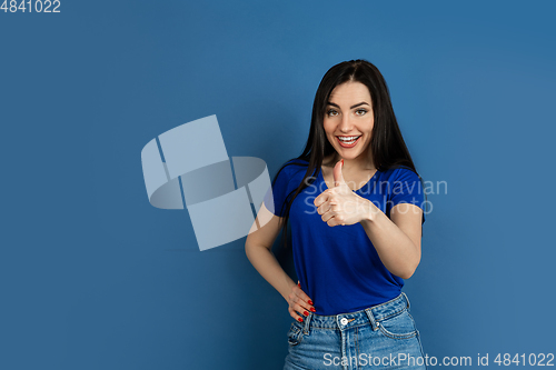 Image of Caucasian woman\'s portrait isolated on blue studio background