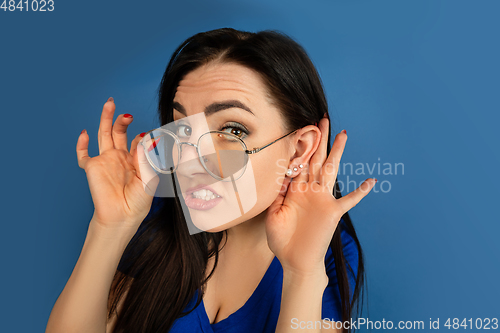 Image of Caucasian woman\'s portrait isolated on blue studio background