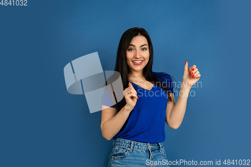 Image of Caucasian woman\'s portrait isolated on blue studio background