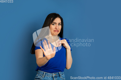 Image of Caucasian woman\'s portrait isolated on blue studio background