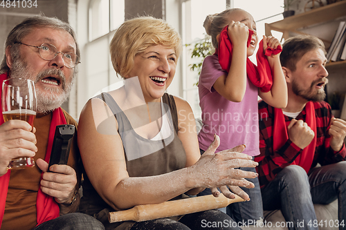 Image of Excited, happy big family team watch football, soccer match together on the couch at home
