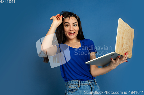 Image of Caucasian woman\'s portrait isolated on blue studio background