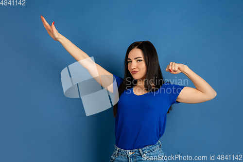 Image of Caucasian woman\'s portrait isolated on blue studio background