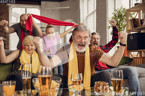 Image of Excited, happy big family team watch football, soccer match together on the couch at home