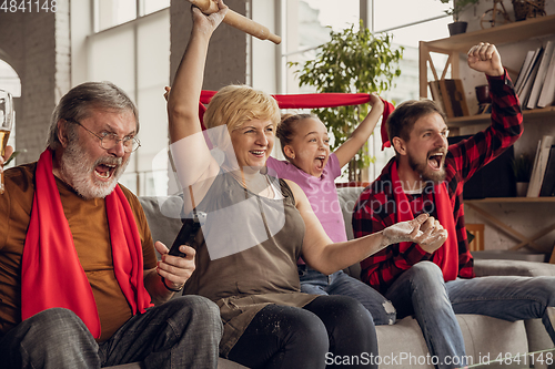 Image of Excited, happy big family team watch football, soccer match together on the couch at home